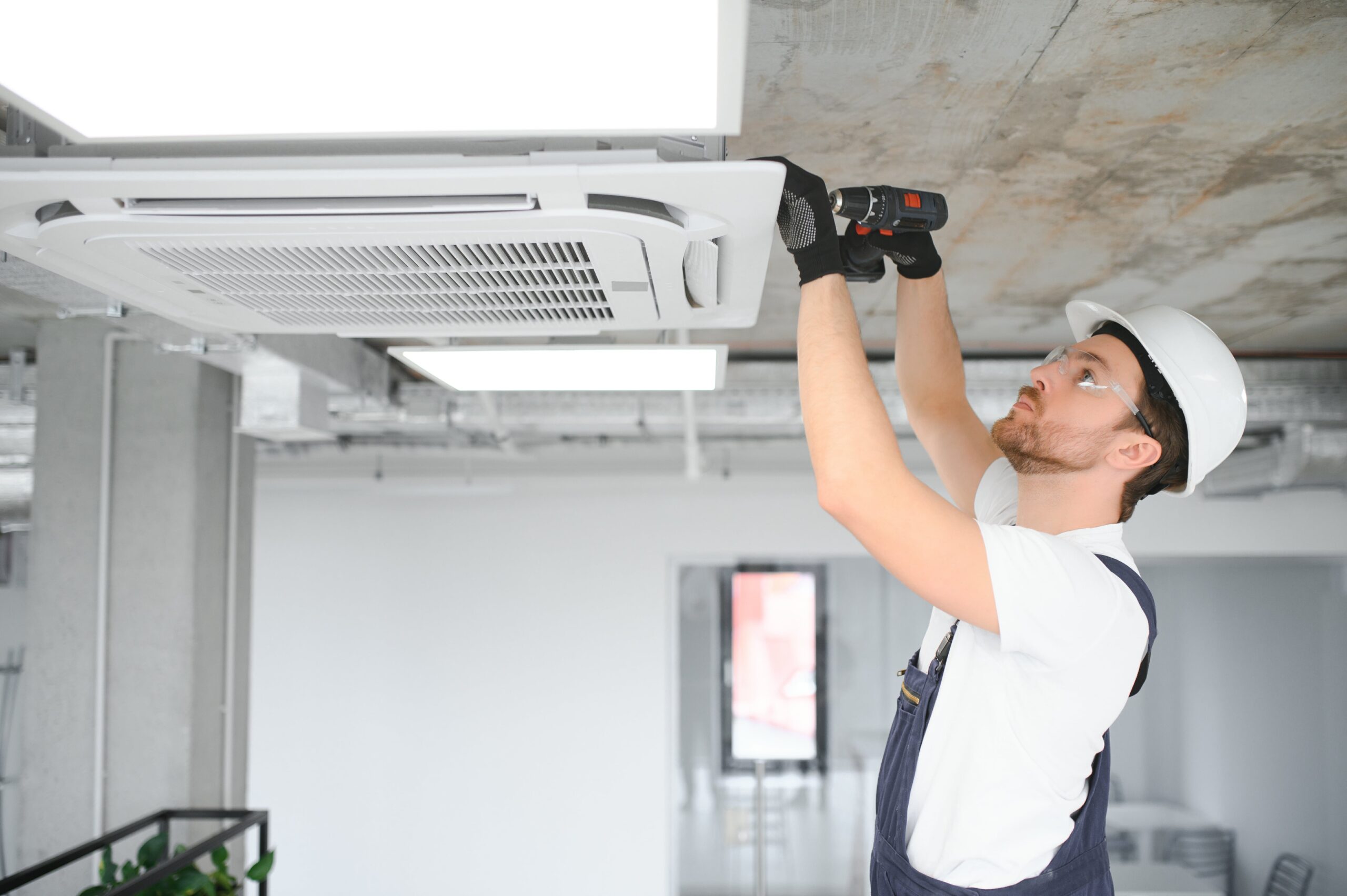 handsome young man electrician installing air cond 2023 11 27 05 27 50 utc min scaled